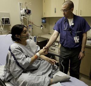 corp-ucsf-ED-resident-patient Patient shaking hands with doctor