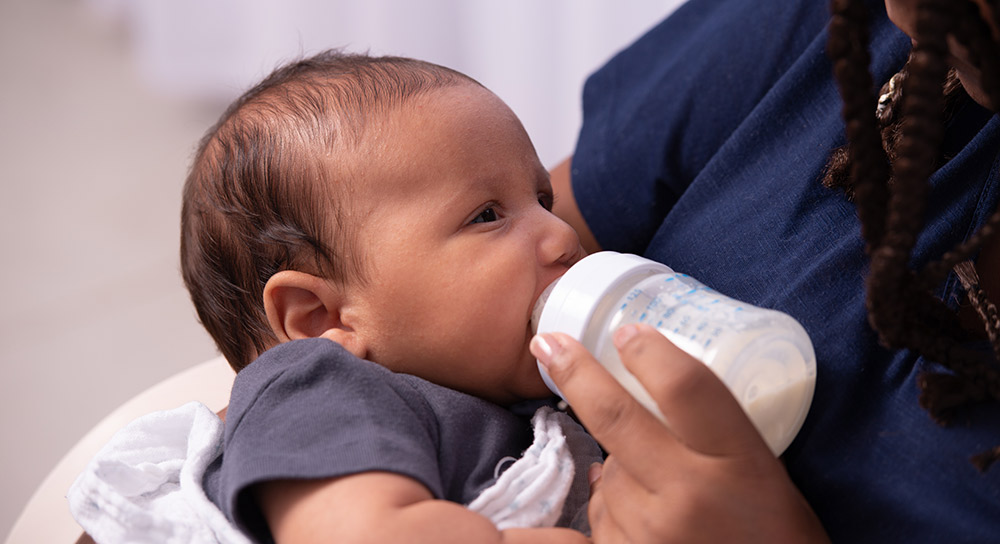baby being fed formula from a bottle