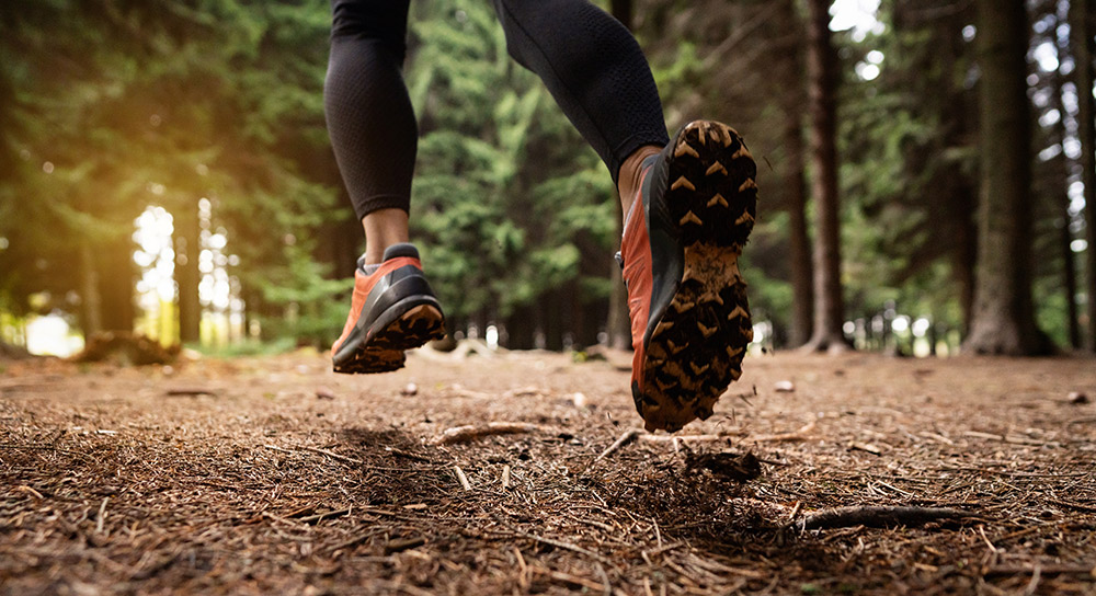Close up of running shoes on a trail in a forest