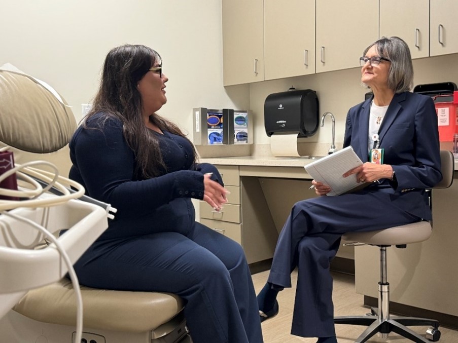 two women talking in a doctor's office