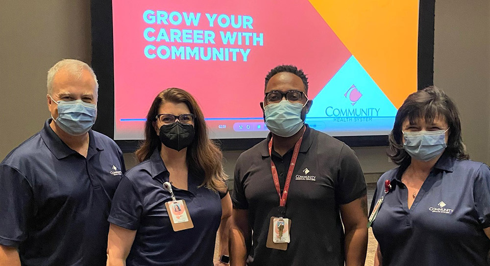 four people at a career fair wearing medical masks