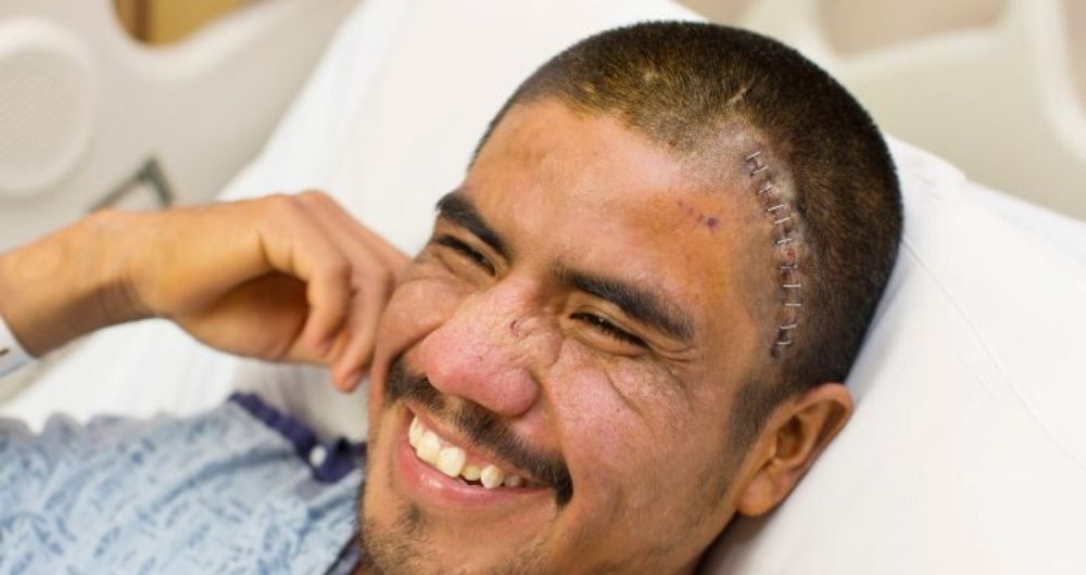 Juan Aquino smiles from his hospital bed