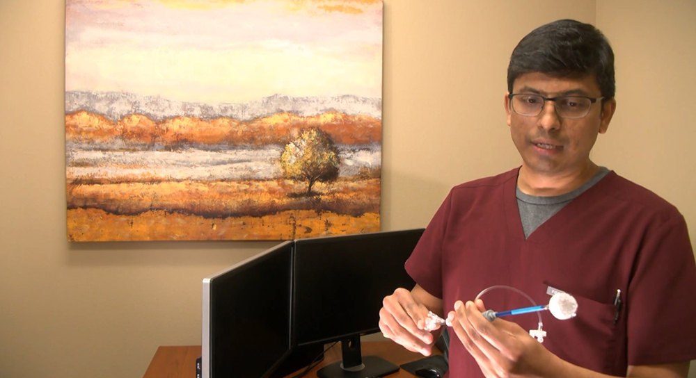 Dr. Palaniswamy shows watchman device